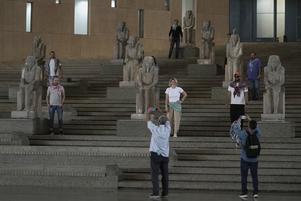 Tourists pose at the Grand staircase at the Grand Egyptian Museum in Giza, Egypt, Friday, May 23, 2025. (AP Photo/Amr Nabil)