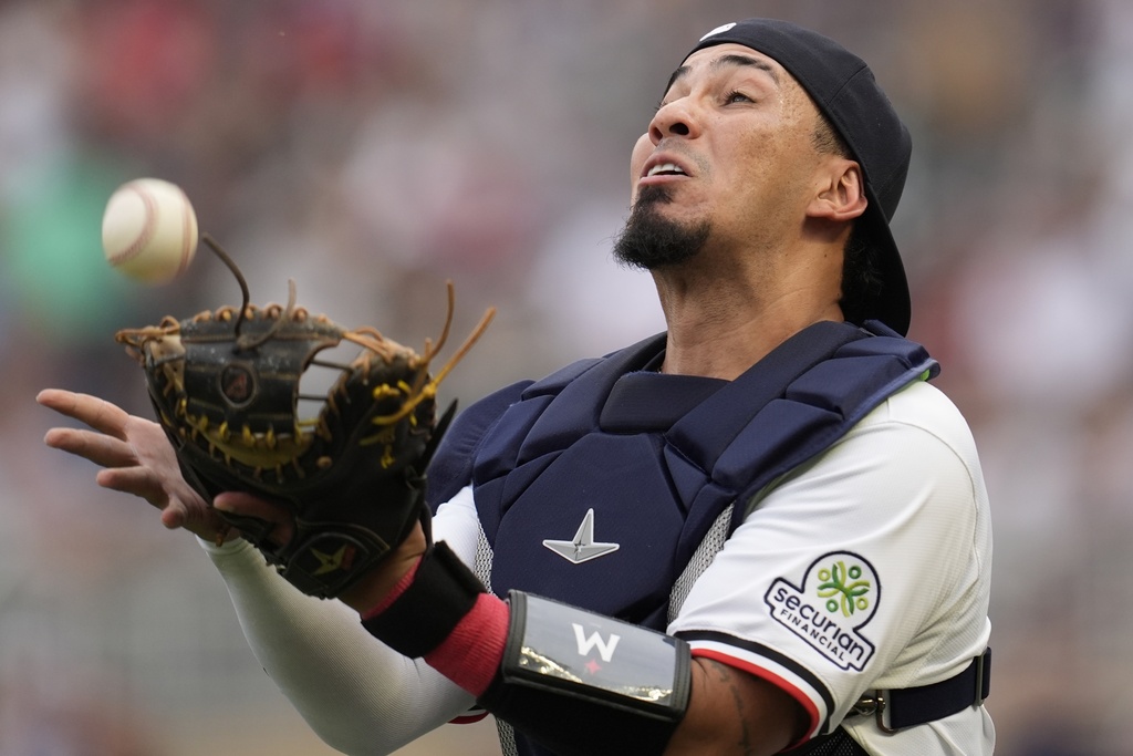 Minnesota Twins catcher Jhonny Pereda (65) makes the catch off the bat of Arizona Diamondbacks' Corbin Carroll in the first inning of a baseball game, Saturday, Sept. 13, 2025, in Minneapolis. (AP Photo/Mike Stewart)