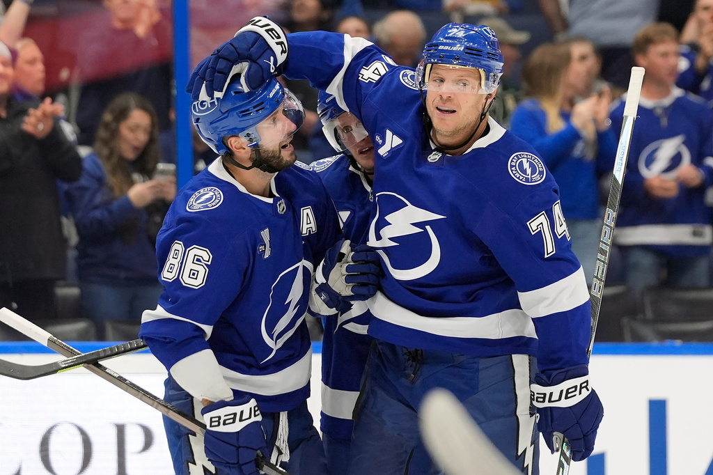 Tampa Bay Lightning defenseman John Carlson (74) celebrates his goal against the Minnesota Wild with right wing Nikita Kucherov (86) during the second period of an NHL hockey game Thursday, Oct. 8, 2026, in Tampa, Fla. (AP Photo/Chris O'Meara)
