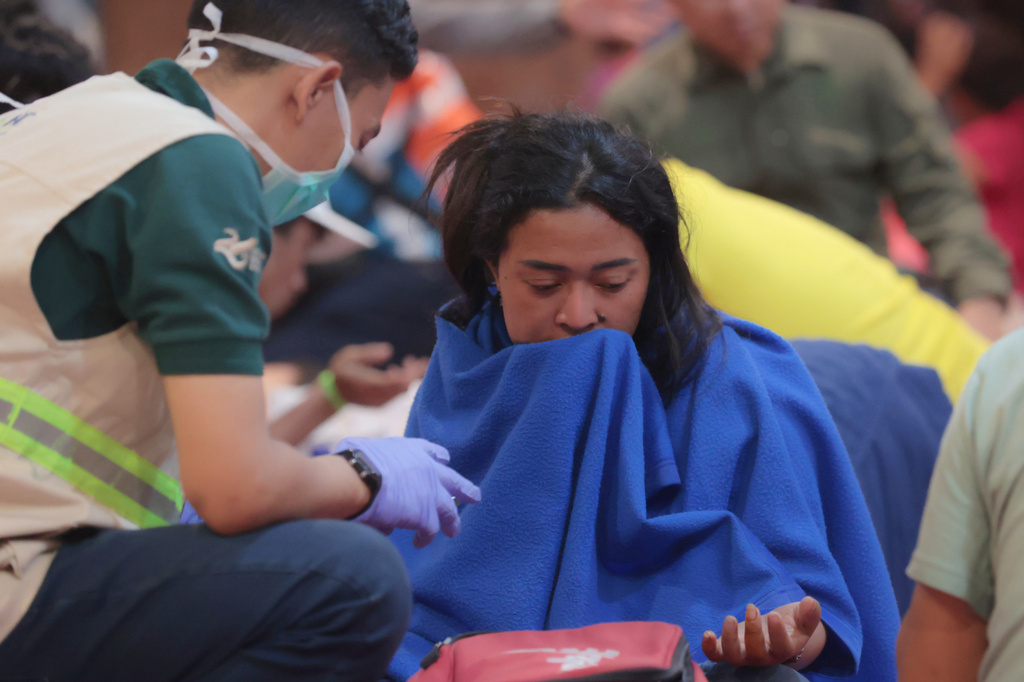 A survivor of a ferry fire receives medical attention at Tanjung Perak Port in Surabaya, East Java, Indonesia, Monday, Aug. 3, 2026. (AP Photo/Trisnadi)