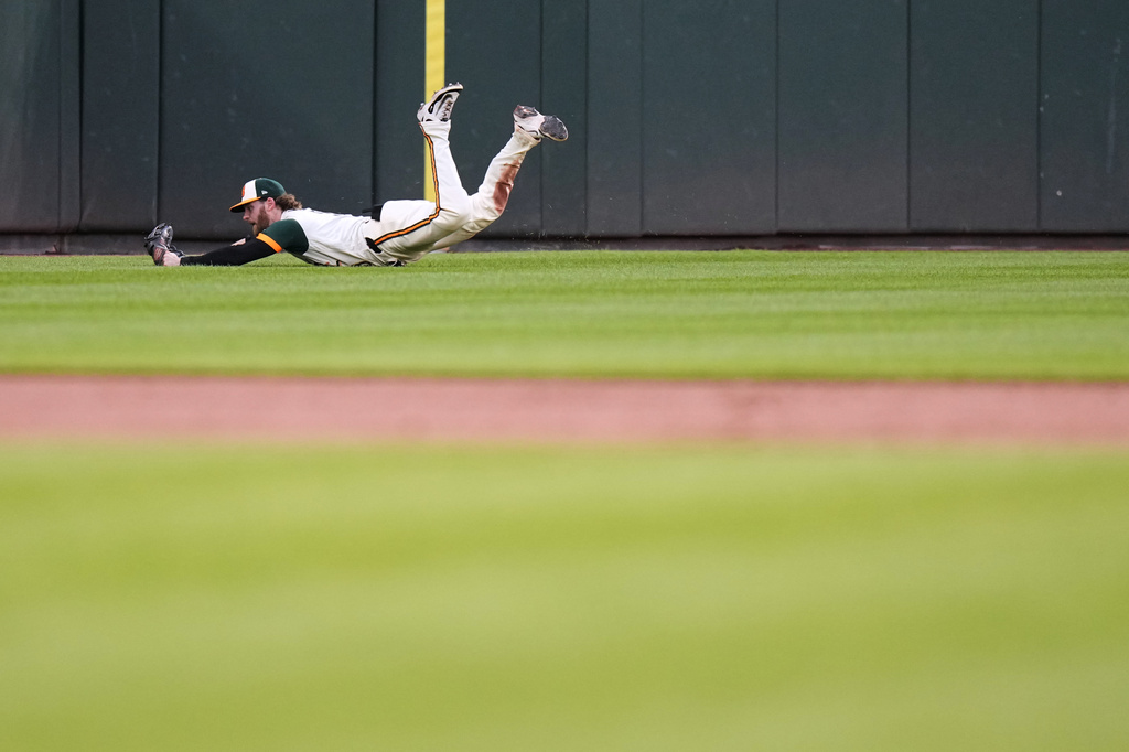 Baltimore Orioles left fielder Taylor Ward dives to catch a fly ball hit by Toronto Blue Jays' Yohendrick Piñango for an out during the third inning of a baseball game, Friday, May 29, 2026, in Baltimore. (AP Photo/Stephanie Scarbrough)
