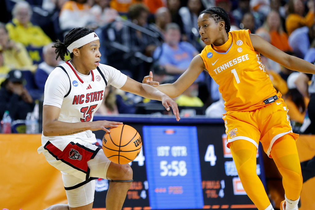 North Carolina State guard Zoe Brooks, left, drives against Tennessee guard Nya Robertson, right, during the first half in the first round of the NCAA college basketball tournament Friday, March 20, 2026, in Ann Arbor, Mich. (AP Photo/Al Goldis)