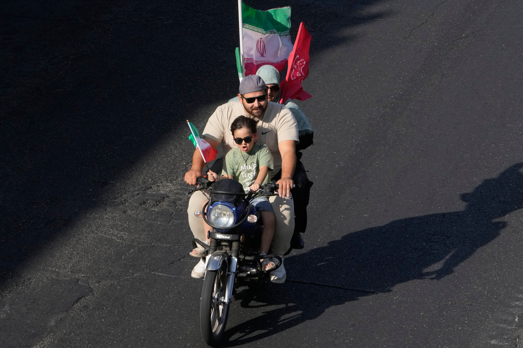 A family ride on a motorcycle during a state-organized motorcycle parade called "Janfada," meaning "Sacrifice for Iran,", in Tehran, Iran, Friday, Sept. 25, 2026. (AP Photo/Vahid Salemi)