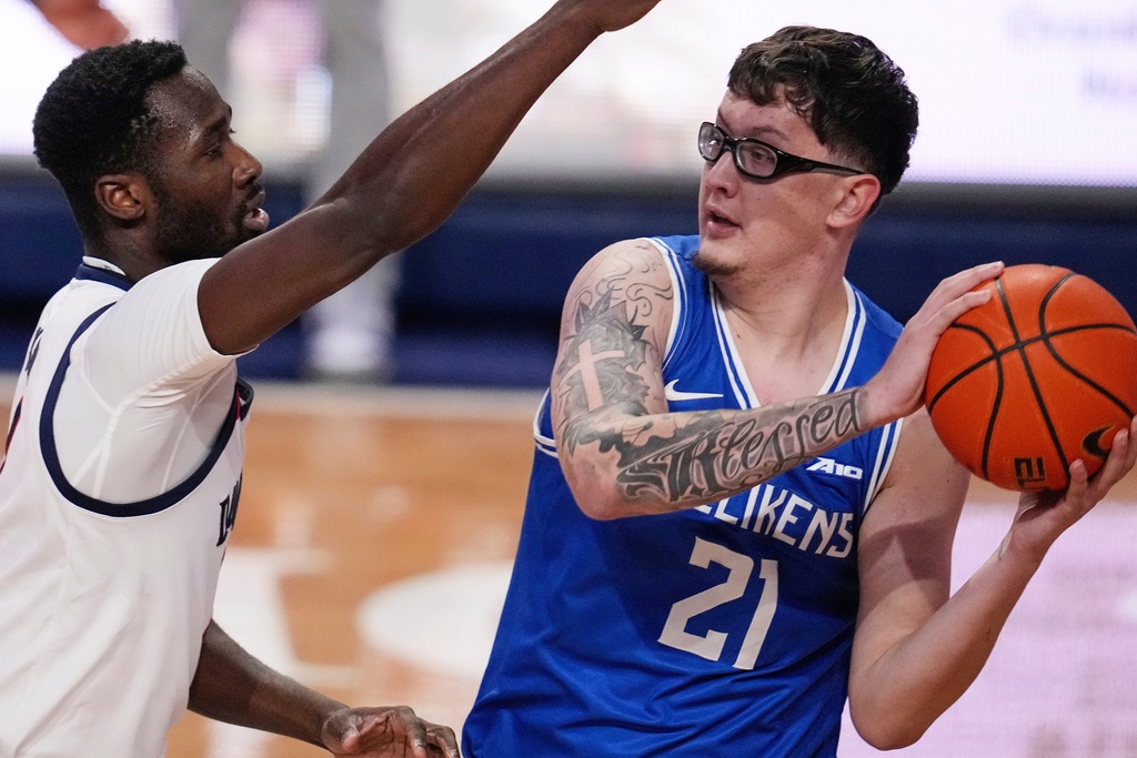 Saint Louis center Robbie Avila (21) looks to pass with Duquesne forward David Dixon defending during the first half of an NCAA college basketball game in Pittsburgh, Tuesday, Jan. 20, 2026. (AP Photo/Gene J. Puskar)