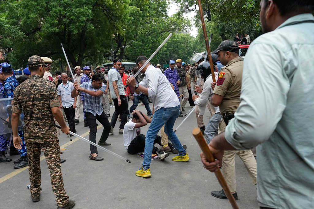 Police use batons to disperse supporters of the Cockroach Janta Party as they attempt to march toward India's Parliament, demanding the resignation of the education minister, in New Delhi, India, Monday, July 20, 2026. (AP Photo/Manish Swarup)