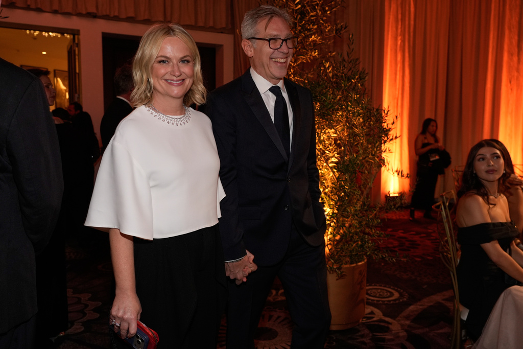 Amy Poehler, left, and Joel Lovell arrive at the 83rd Golden Globes on Sunday, Jan. 11, 2026, at the Beverly Hilton in Beverly Hills, Calif. (AP Photo/Chris Pizzello)
