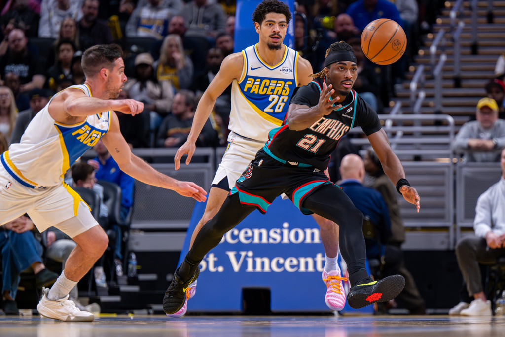 Memphis Grizzlies guard Jahmai Mashack (21) reaches for a loosthe ball during the second half of an NBA basketball game against the Indiana Pacers in Indianapolis, Sunday, March 1, 2026. (AP Photo/Doug McSchooler)