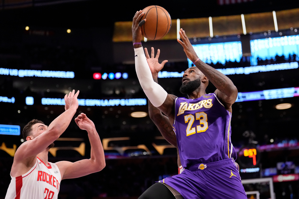 Los Angeles Lakes' LeBron James shoots as Houston Rockets' Alperen Sengun defends during the first half in Game 5 of a first-round NBA playoffs basketball series Wednesday, April 29, 2026, in Los Angeles. (AP Photo/Mark J. Terrill)