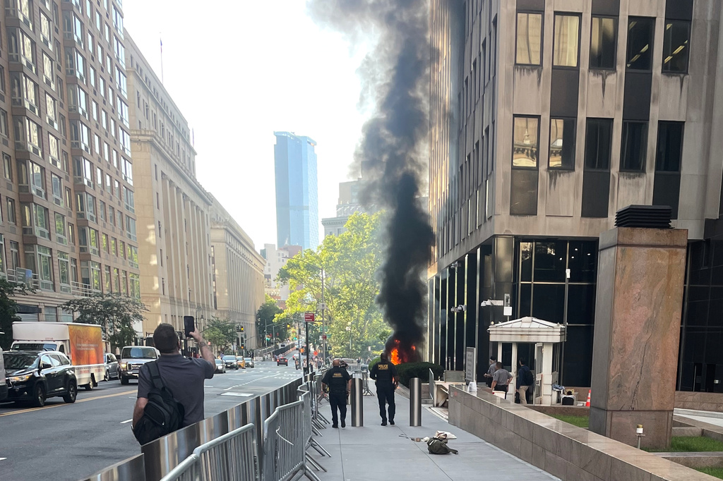 This photo provided by Robert Sullivan shows black smoke and flames in front of 26 Federal Plaza in lower Manhattan, Monday, July 20, 2026, in New York. (Robert Sullivan via AP)