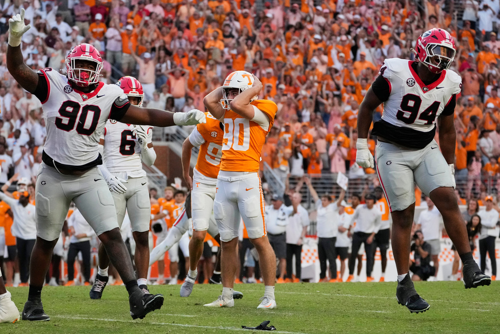 FILE - Georgia defensive linemen Elijah Griffin (90) and Xzavier McLeod (94) celebrate after Tennessee place-kicker Max Gilbert (90), center, misses a game winning field goal during the second half of an NCAA college football game, Sept. 13, 2025, in Knoxville, Tenn. (AP Photo/George Walker IV, File)