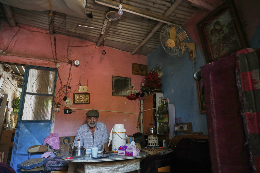 Alawite man sits on his ramshackle house in Sumariya, a suburb northwest of Damascus, Syria, Saturday, Aug. 30, 2025. (AP Photo/Omar Sanadiki)