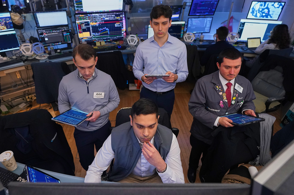 Niall Pawa, foreground center, works with fellow traders on the floor of the New York Stock Exchange, Monday, June 1, 2026. (AP Photo/Richard Drew)