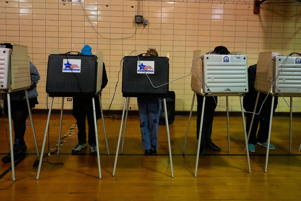 Democratic candidate for Congress, Kat Abughazaleh, center, casts her vote in a primary election for the upcoming midterms, in Chicago, Tuesday, March 17, 2026. (AP Photo/Nam Y. Huh)