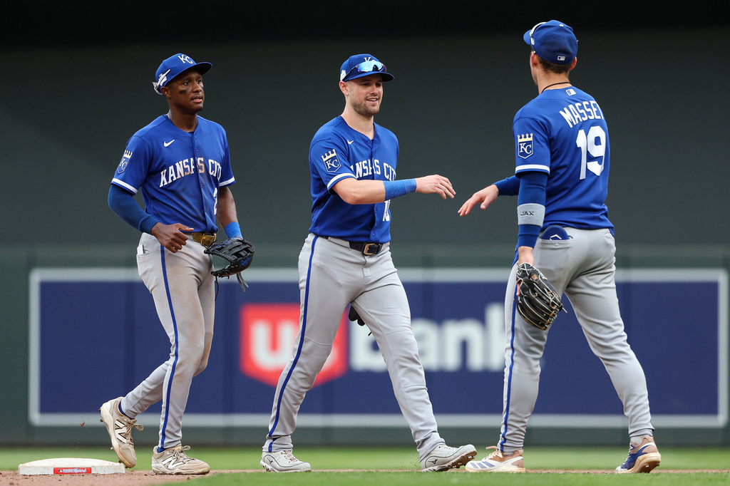 Kansas City Royals center fielder Lane Thomas, middle, and second baseman Michael Massey celebrate their teams win against the Minnesota Twins after a baseball game, Sunday, June 7, 2026, in Minneapolis. (AP Photo/Matt Krohn)