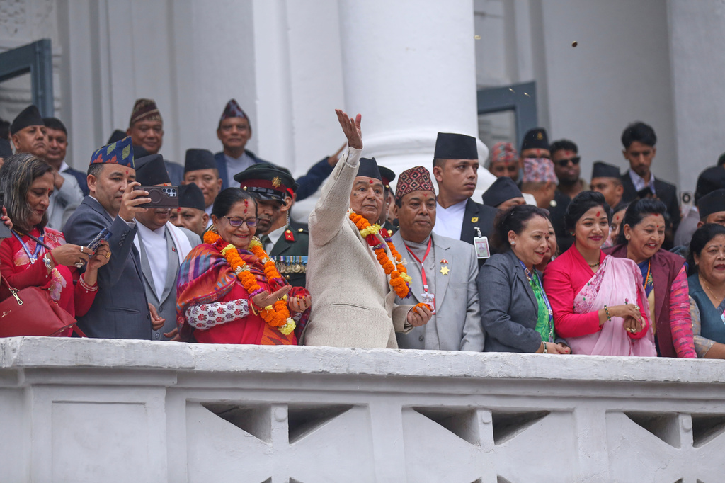 Nepalese president Ram Chandra Paudel throws coins as he offers prayers during Indra Jatra, a festival that marks the end of the rainy season in Kathmandu, Nepal, Friday, Sept. 25, 2026. (AP Photo/Subash Shrestha)