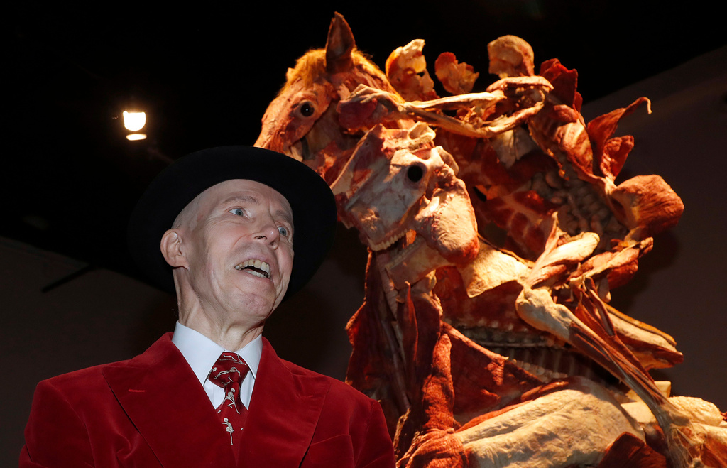 FILE - Gunther von Hagen poses in front of the sculpture 'Rearing Horse with Rider' during the launch of Gunther von Hagens' Body Worlds museum in London, Thursday, Oct. 4, 2018. (AP Photo/Frank Augstein, file)