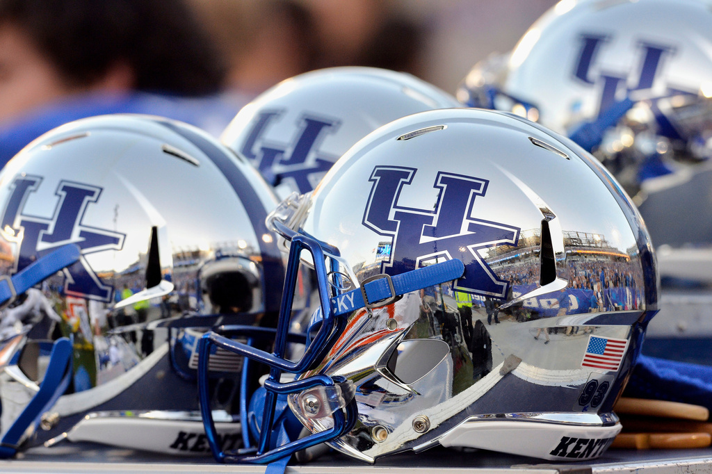 FILE - Commonwealth Stadium is reflected in Kentucky helmets during the third quarter of an NCAA college football game at Commonwealth Stadium in Lexington, Ky., Saturday, Oct. 25, 2014. (AP Photo/Timothy D. Easley, File)