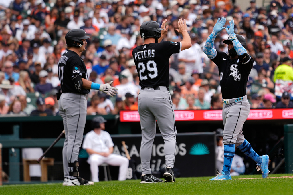 Chicago White Sox's Luisangel Acuña (0) celebrates his two-run home run with Tristan Peters (29) and Sam Antonacci (17) against the Detroit Tigers during the sixth inning of a baseball game Sunday, June 21, 2026, in Detroit. (AP Photo/Paul Sancya).