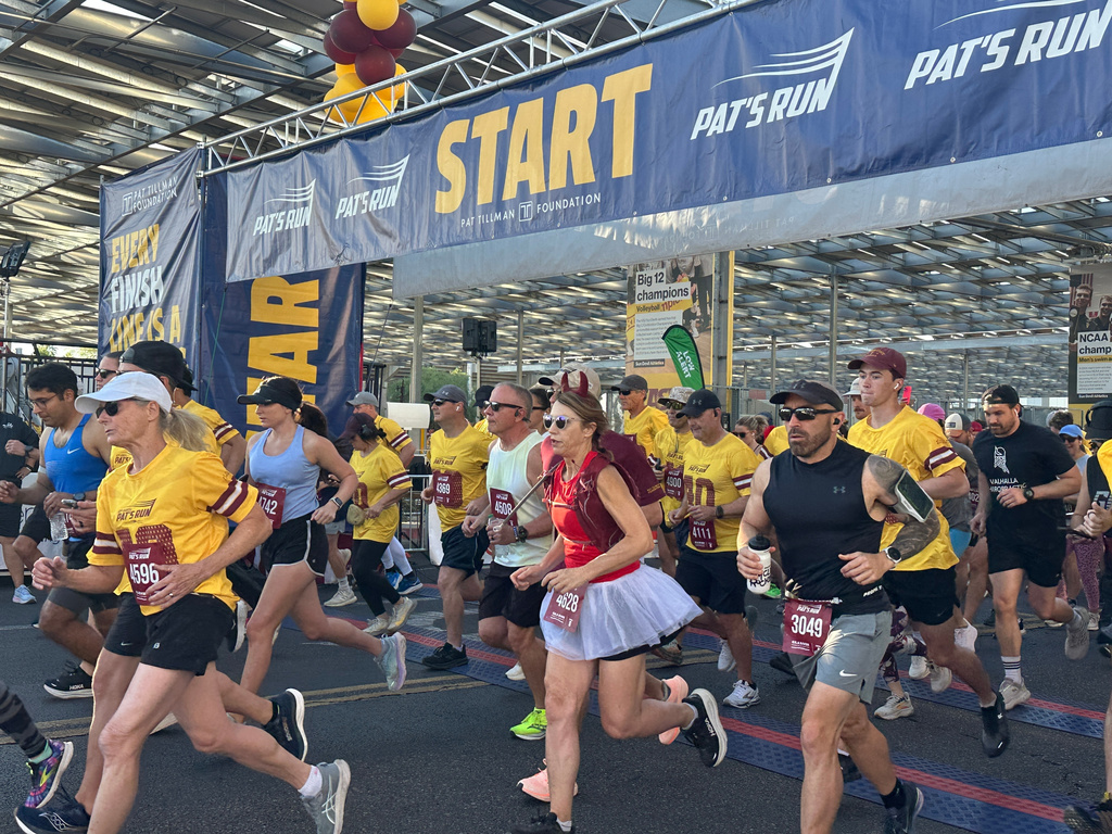 Runners take off at the start line of Pat's Run, a 4.2-mile race honoring former NFL player and Army Ranger Pat Tillman, in Tempe, Ariz., on Saturday, April 11, 2026. (AP Photo/John Marshall)