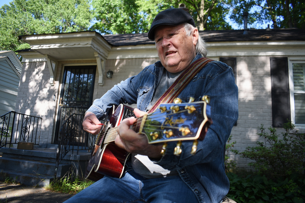 Steve Fowler, a Beale Street musician whose street was bisected by Tennessee's new congressional districts, strums the guitar in his front yard on Thursday, May 7, 2026, in Memphis, Tenn. (AP Photo/Sophie Bates)