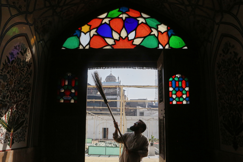 A worker cleans an area of the historic Mahabat Khan mosque in preparation for the upcoming Muslim fasting month of Ramadan, in Peshawar, Pakistan, Monday, Feb. 16, 2026. (AP Photo/Muhammad Sajjad)