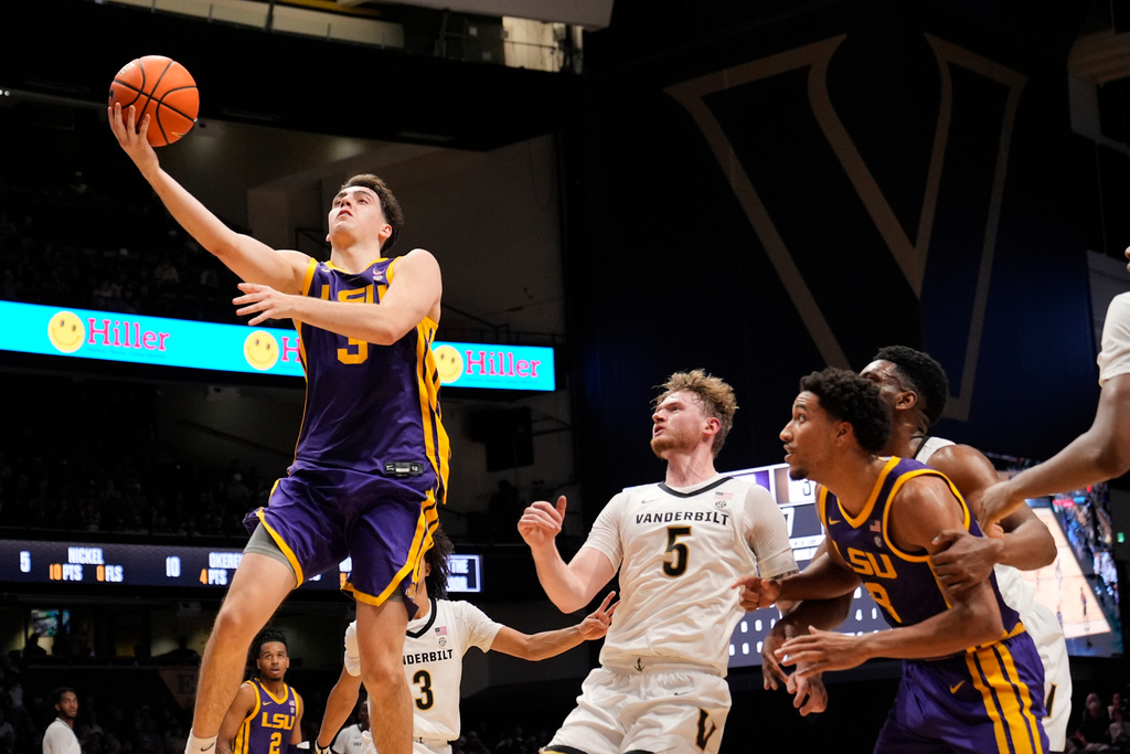 LSU guard Max MacKinnon (3) shoots the ball past Vanderbilt forward Tyler Nickel (5) during the first half of an NCAA college basketball game Saturday, Jan. 10, 2026, in Nashville, Tenn. (AP Photo/George Walker IV)
