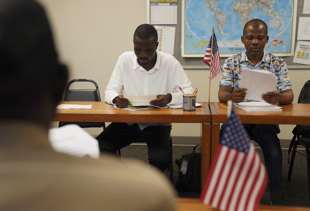 Five men from China, Benin, Congo, Togo and Sudan, and a Guatemalan woman and her son, take a citizenship class at The Catherine McAuley Center, founded by the Catholic Sisters of Mercy order, on Saturday, Aug. 9, 2025, in Cedar Rapids, Iowa. (AP Photo/Jessie Wardarski)