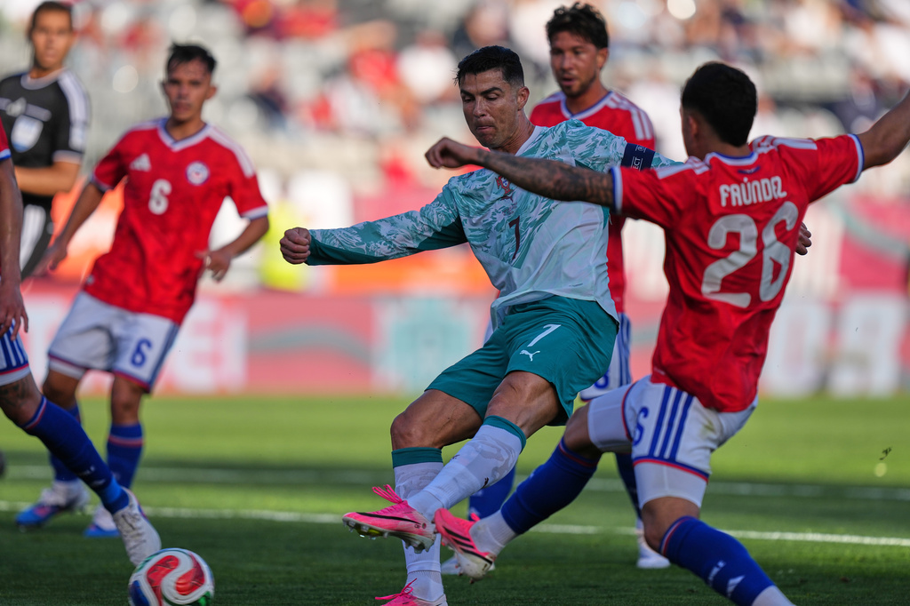 Portugal's Cristiano Ronaldo, center, and Chile's Felipe Faundez challenge for the ball during an international friendly soccer match between Portugal and Chile in Oeiras, outside Lisbon, Saturday, June 6, 2026. (AP Photo/Armando Franca)