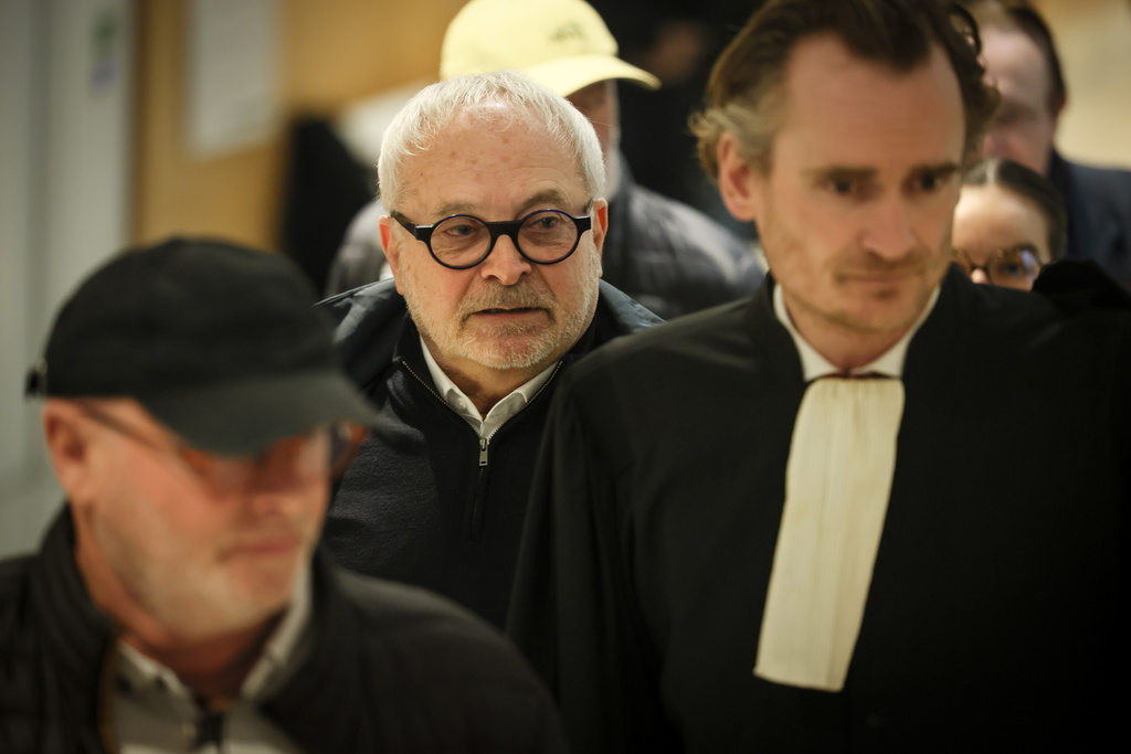 French former senator Joel Guerriau, center, and his lawyer Henri Carpentier, arrive at the courtroom, in Paris, Monday, Jan. 26, 2026. (AP Photo/Thomas Padilla)
