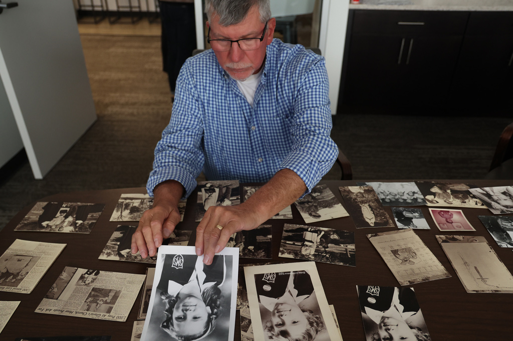 FILE - Adam Kowalewicz holds a photo of his slain sister, Gloria, as he displays family photos during an interview with the Chicago Tribune on Oct. 9, 2026. (Antonio Perez /Chicago Tribune via AP)