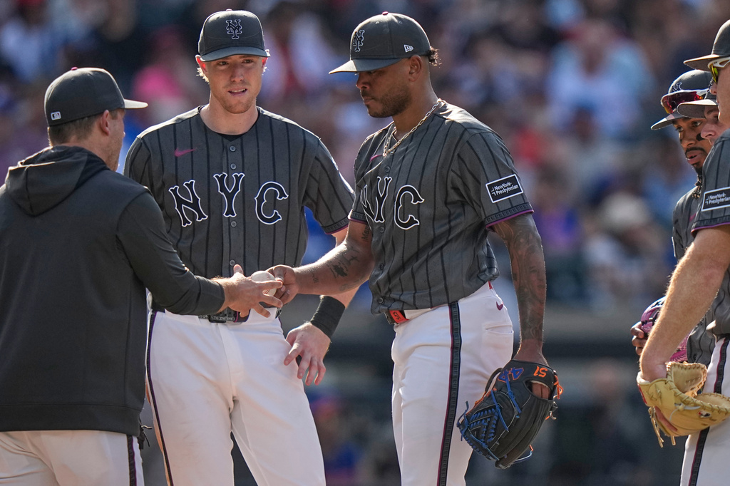 New York Mets pitcher Freddy Peralta, right, hands the ball to interim manager Andy Green, left, as he leaves during the fifth inning of a baseball game against the Boston Red Sox Saturday, July 11, 2026, in New York. (AP Photo/Frank Franklin II)