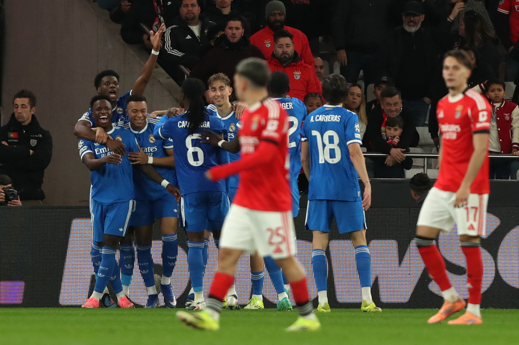 Real Madrid's Vinicius Junior celebrates with team mates the opening goal during a Champions League playoff soccer match between SL Benfica and Real Madrid in Lisbon, Portugal, Tuesday, Feb. 17, 2026. (AP Photo/Pedro Rocha)