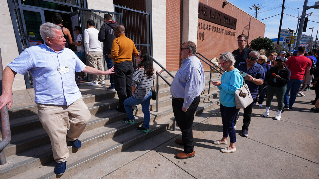 Voters stand in line to vote early for the primary election, in Dallas, Tuesday, Feb. 17, 2026. (AP Photo/LM Otero)
