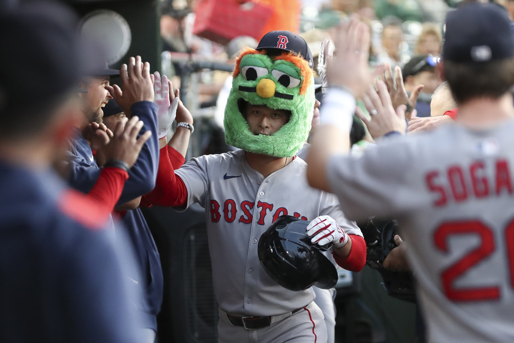 Boston Red Sox's Rob Refsnyder celebrates with his teammates after hitting a three run home run during the first inning of a baseball game against the Athletics, Tuesday, Sept. 9, 2025, in West Sacramento, Calif. (AP Photo/Scott Marshall)