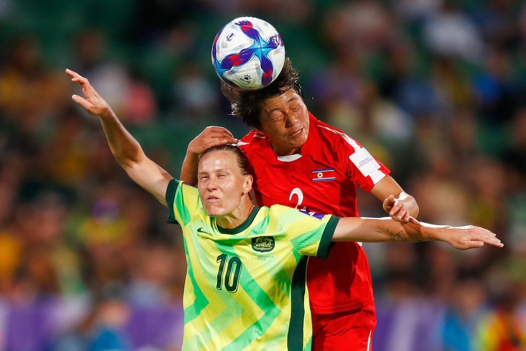 Australia's Emily van Egmond, front, and North Korea's Ri Myong gum compete for the ball during the Women's Asian Cup quarterfinal soccer match between Australia and North Korea in Perth, Australia, Friday, March 13, 2026. (AP Photo/Gary Day)