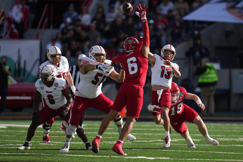Miami quarterback Thomas Gotkowski (13) throws downfield against Fresno State in the first half of the Snoop Dogg Arizona Bowl NCAA college football game, Saturday, Dec. 27, 2025, in Tucson, Ariz. (AP Photo/Rick Scuteri)
