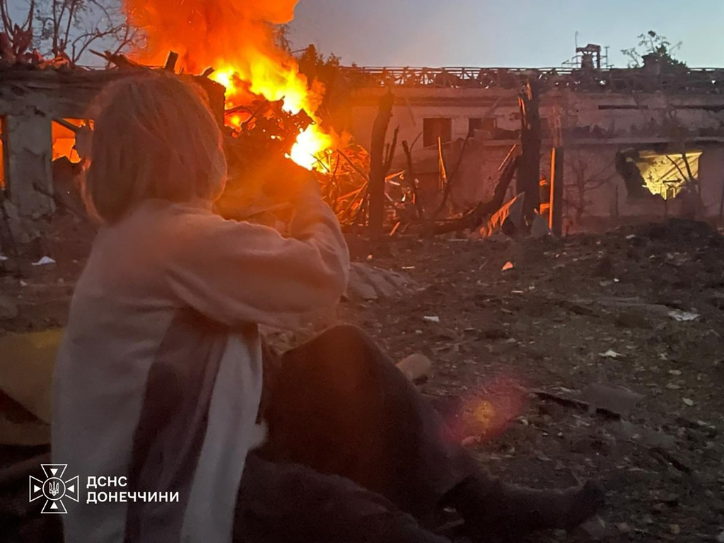 In this photo provided by the Ukrainian Emergency Service, a woman looks at a residential building damaged by a Russian air strike in Sloviansk, Donetsk region, Ukraine, Monday, Aug. 31, 2026. (Ukrainian Emergency Service via AP)