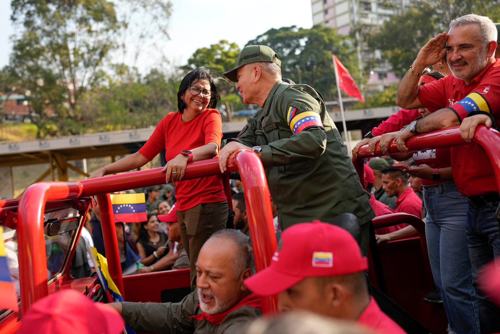 FILE - Vice President Delcy Rodriguez, left, smiles at Venezuelan Defense Minister Padrino Lopez, as they take the route that the body of late President Hugo Chavez was transported to his final resting place, during the activities marking the 10th anniversary of Chavez's death, in Caracas, Venezuela, March 15, 2023. (AP Photo/Matias Delacroix, File)