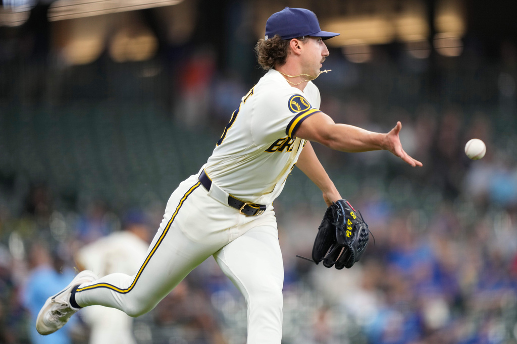 Milwaukee Brewers pitcher Brandon Sproat tosses the ball to first base to force out Toronto Blue Jays' Tyler Heineman on a sacrifice bunt during the third inning of a baseball game, Thursday, April 16, 2026, in Milwaukee. (AP Photo/Kayla Wolf)