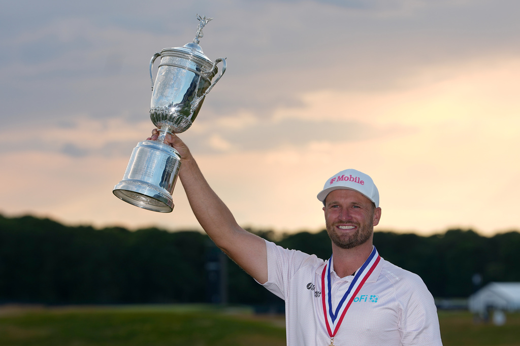 Wyndham Clark holds the trophy after winning the U.S. Open golf tournament at Shinnecock Hills Golf Club in Southampton, N.Y., Sunday, June 21, 2026. (AP Photo/Gerald Herbert)