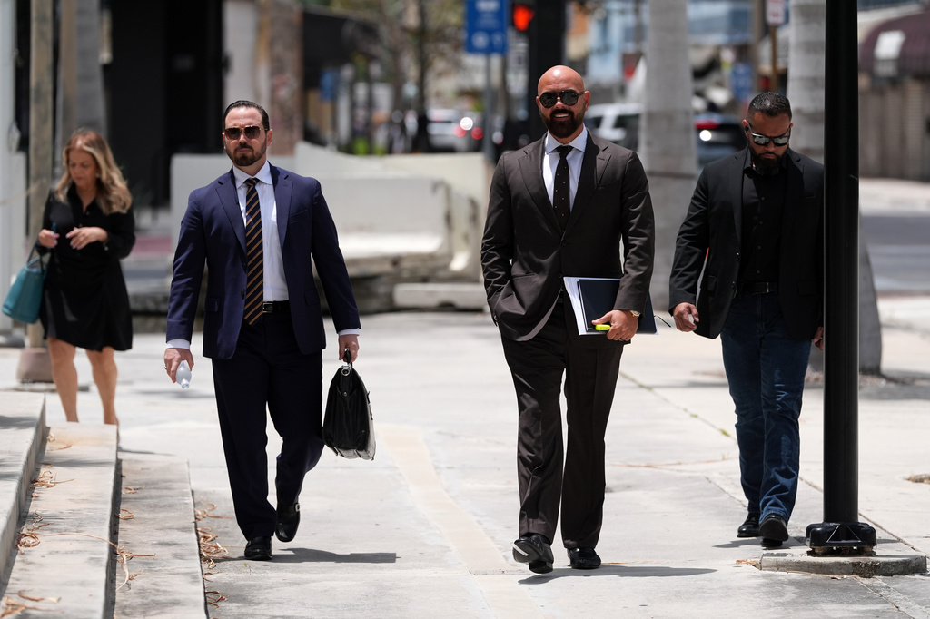 Attorney Joseph McBride, second right, representing Andrew and Tristan Tate after they were arrested to face rape and sex trafficking charges against them in the United Kingdom, arrives at the C. Clyde Atkins U.S. Courthouse, Monday, July 27, 2026, in Miami. (AP Photo/Rebecca Blackwell)