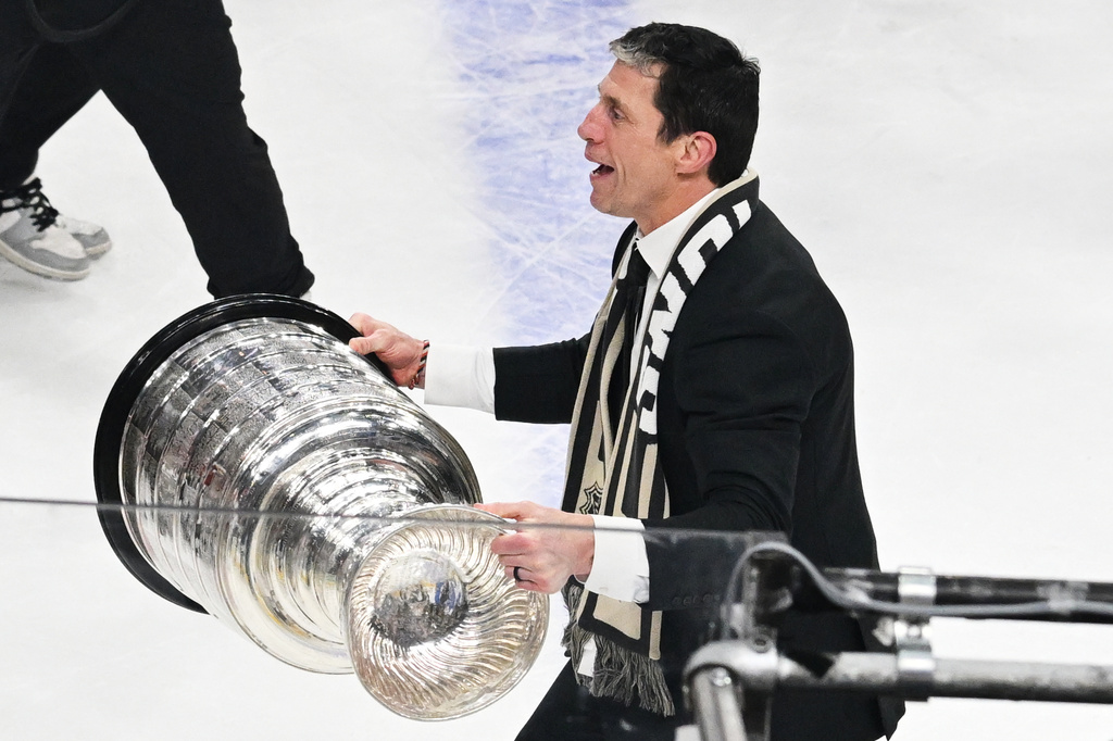 FILE - Carolina Hurricanes head coach Rod Brind'Amour, right, lifts the Stanley Cup after a win over the Vegas Golden Knights in Game 6 of the NHL hockey Stanley Cup Final series, June 14, 2026, in Las Vegas. (AP Photo/Candice Ward, File)