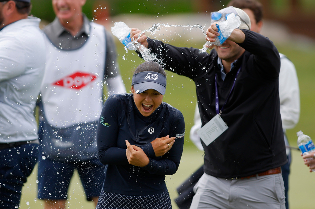 Yana Wilson, center, is doused on the 18th hole after winning the Dow Championship LPGA golf tournament, Sunday, June 14, 2026, at Midland Country Club in Midland, Mich. (AP Photo/Al Goldis)