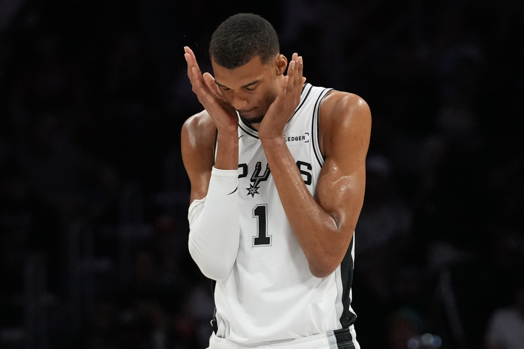 San Antonio Spurs forward Victor Wembanyama (1) walks on the court during the first half of an NBA basketball game against the Miami Heat, Monday, March 23, 2026, in Miami. (AP Photo/Lynne Sladky)