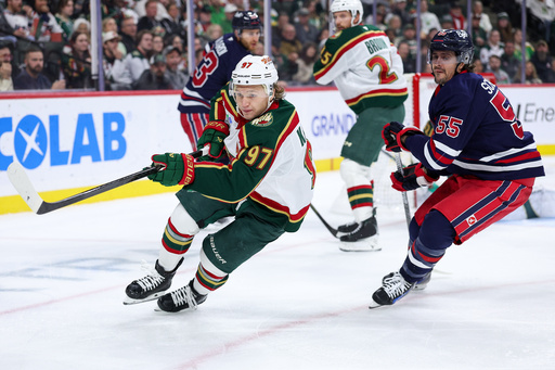 Minnesota Wild left wing Kirill Kaprizov, left, skates for the puck alongside Winnipeg Jets center Mark Scheifele during the second period of an NHL hockey game Tuesday, Oct. 28, 2025, in St. Paul, Minn. (AP Photo/Matt Krohn) Minnesota Wild left wing Kirill Kaprizov, left, skates for the puck alongside Winnipeg Jets center Mark Scheifele during the second period of an NHL hockey game Tuesday, Oct. 28, 2025, in St. Paul, Minn. (AP Photo/Matt Krohn)