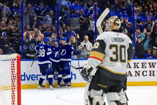 Tampa Bay Lightning's Nikita Kucherov, center back left, celebrates after his winning goal against Vegas Golden Knights' Carl Lindbom (30) with teammates Brandon Hagel (38) and J.J. Moser (90) during the overtime period of an NHL hockey game Sunday, Oct. 26, 2025, in Tampa, Fla. (AP Photo/Mike Carlson) Tampa Bay Lightning's Nikita Kucherov, center back left, celebrates after his winning goal against Vegas Golden Knights' Carl Lindbom (30) with teammates Brandon Hagel (38) and J.J. Moser (90) during the overtime period of an NHL hockey game Sunday, Oct. 26, 2025, in Tampa, Fla. (AP Photo/Mike Carlson)