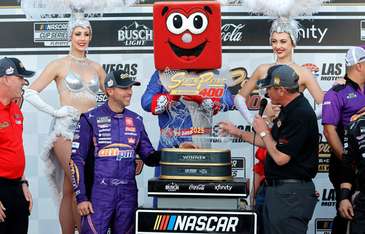 Ryan Growney, center right, general manager of the South Point Hotel and Casino, presents the trophy to Denny Hamlin, center left, in Victory Lane after Hamlin won a NASCAR Cup Series auto race Sunday, Oct. 12, 2025, in Las Vegas. (AP Photo/Steve Marcus) Ryan Growney, center right, general manager of the South Point Hotel and Casino, presents the trophy to Denny Hamlin, center left, in Victory Lane after Hamlin won a NASCAR Cup Series auto race Sunday, Oct. 12, 2025, in Las Vegas. (AP Photo/Steve Marcus)
