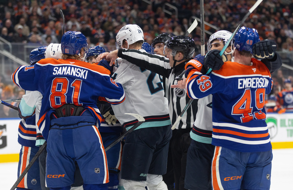 Seattle Kraken and the Edmonton Oilers players rough it up during third period NHL action, in Edmonton on Tuesday March 31, 2026. (Jason Franson/The Canadian Press via AP)
