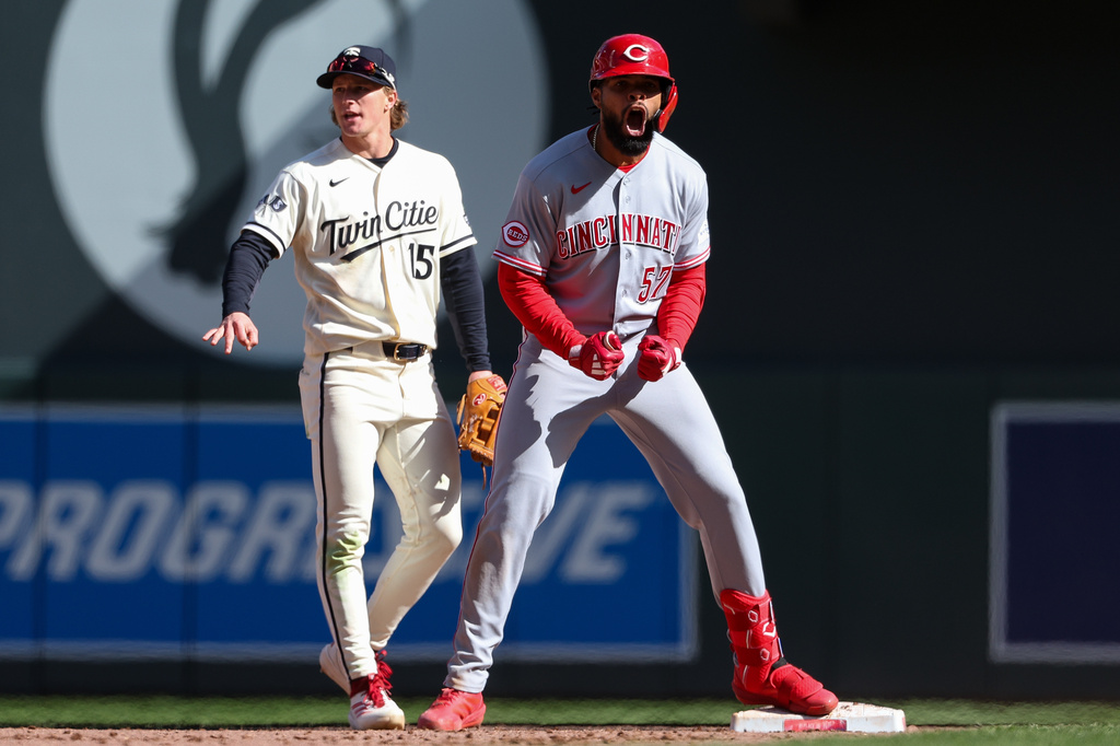 Cincinnati Reds' Rece Hinds, right, celebrates after his RBI double against the Minnesota Twins during the 10th inning of baseball game, Sunday, April 19, 2026, in Minneapolis. (AP Photo/Matt Krohn)