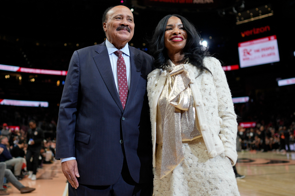 Martin Luther King III, and his wife Arndrea Waters King smile during the second half of an NBA basketball game between the Atlanta Hawks and the Milwaukee Bucks, Monday, Jan. 19, 2026, in Atlanta. (AP Photo/Mike Stewart)